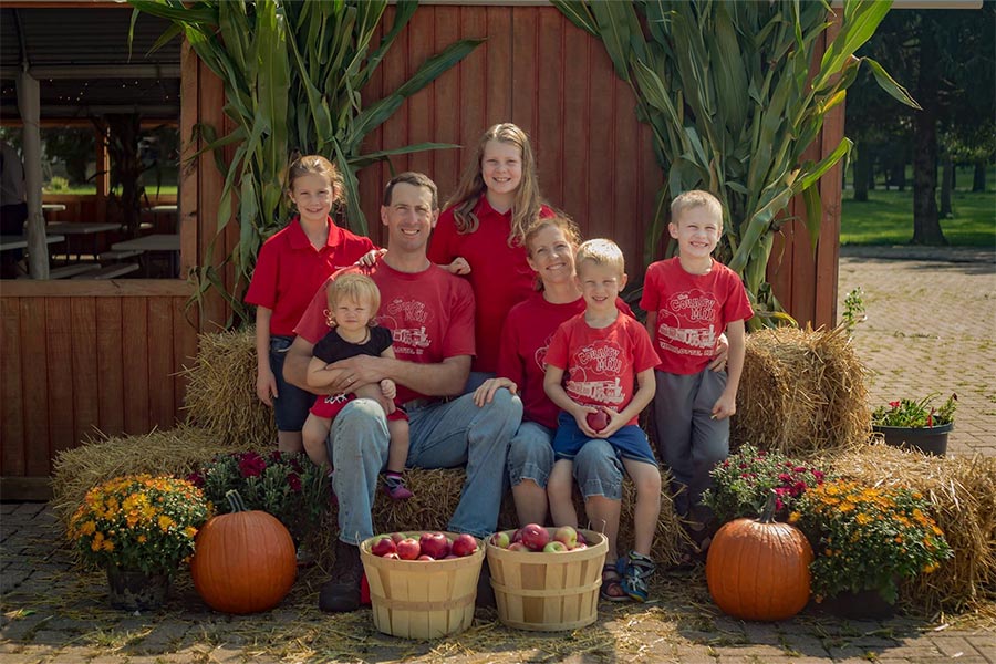 Steve and Bridget Tennes and their children pose for a family photo on their family farm