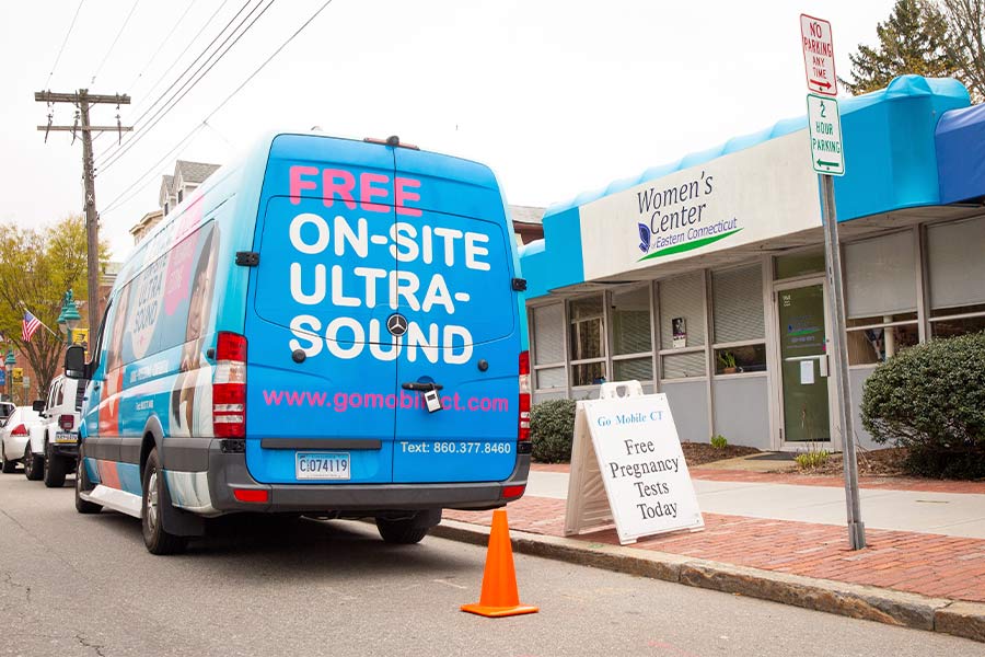 The mobile pregnancy center of Caring Families Pregnancy parks on the side of the street