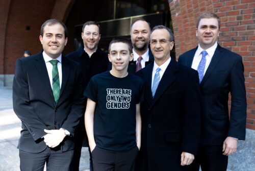 Liam Morrison and attorneys smiling
