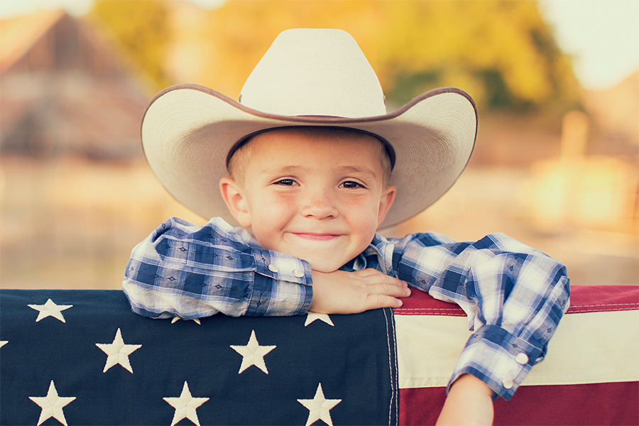 Young cowboy with the American flag