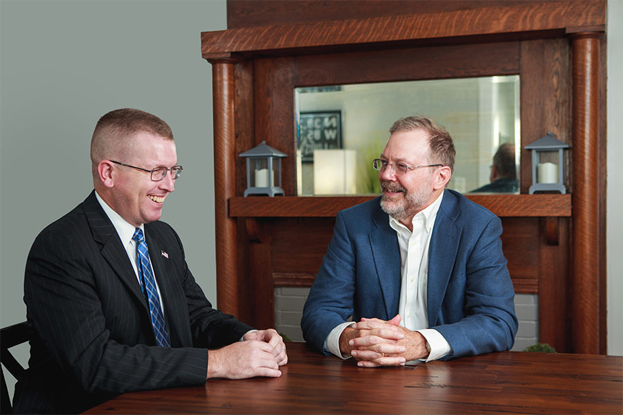 Dr. Nicholas Meriwether is pictured sitting at a table talking with an ADF attorney
