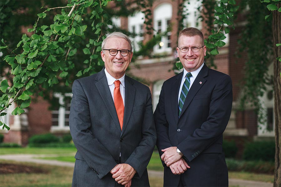 Dr. Allan Josephson (left) and Travis Barham stand next to each other smiling.