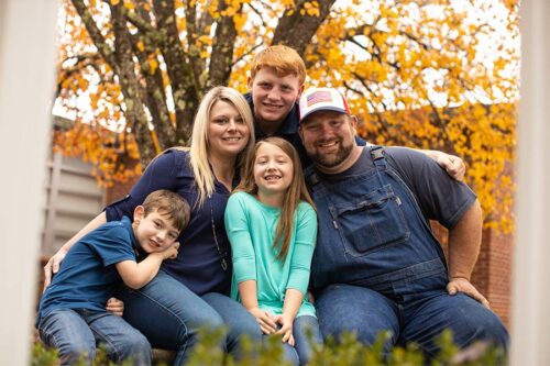 Lydia Booth, center, poses with her mom, dad, and brothers.